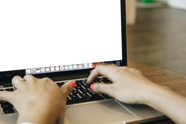 A close-up view of a person's hands using a laptop. The screen displays a website resembling a government unclaimed property search portal. A magnifying glass hovers near the screen, symbolizing the act of searching for lost assets.